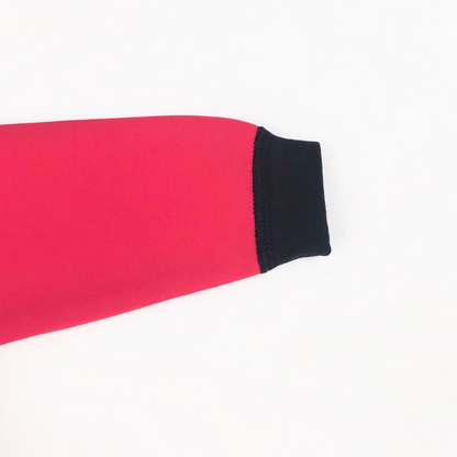 Detalle manga raglan roja con puño azul marino